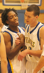 Matt Stoll, right, is congratulated by Rowmell Crawford after dunking for two of his 19 points.